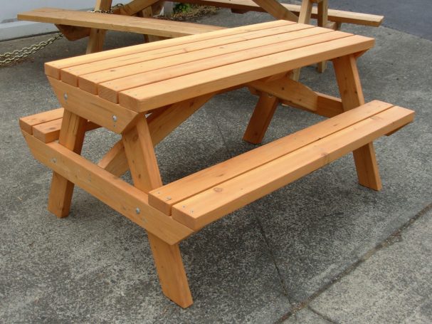 4' Commercial quality Eco-friendly Outdoor Kids Attached Bench Picnic Table slanted to the right on a sidewalk.
