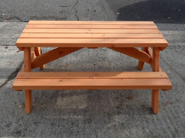 Commercial quality Eco-friendly Outdoor Kids Attached Bench Picnic Table from the side on a sidewalk.