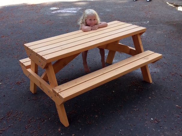 Little girl sitting at a Commercial quality Eco-friendly Outdoor Kids Attached Bench Picnic Table slanted to the right.