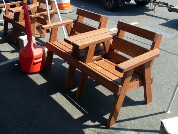 5' Commercial quality eco-friendly Outdoor Park Benches with center table slanted to the left at a restaurant bar.